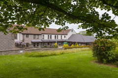 Forbes Court building with tree and grass area in the foreground