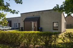 Strachan Cottages building with bushes and parking spaces