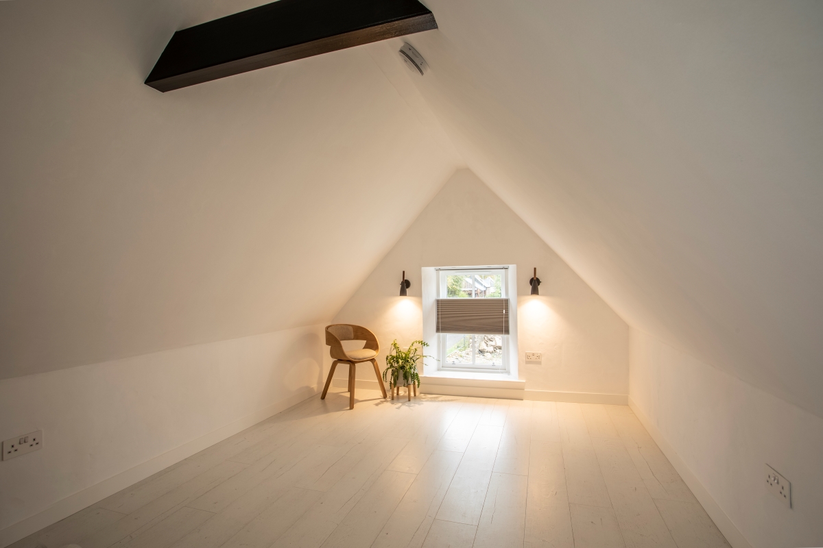 Top floor of St Margarets with sloped triangle roof, small window and chair