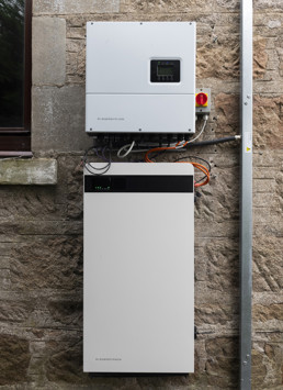 Battery storage unit on the outside wall of a home. The cover is has been taken off.