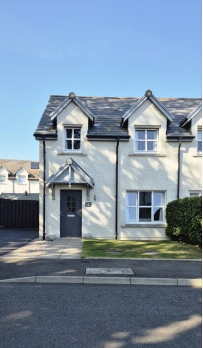 Front of the house at Forbes Park in Echt with paved path to the front door, grass area to the right and driveway to the left